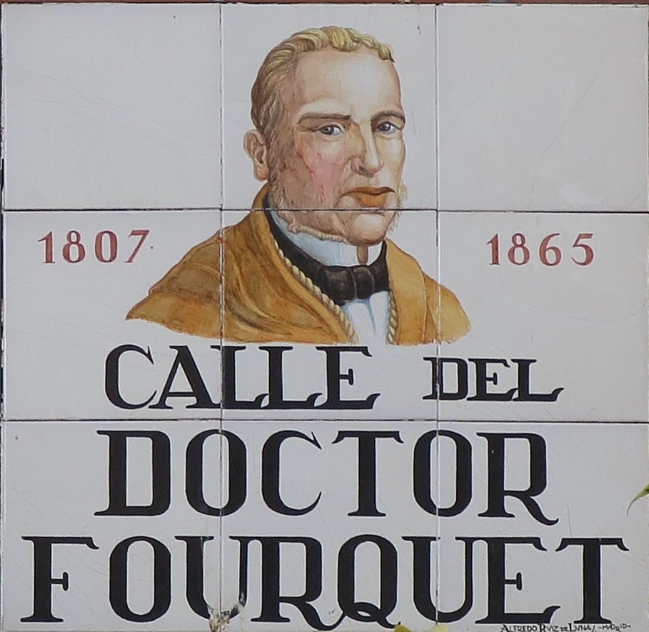 A ceramic tile street sign for Calle del Doctor Fourquet, featuring a painted portrait of the doctor and the years 1807 and 1865.