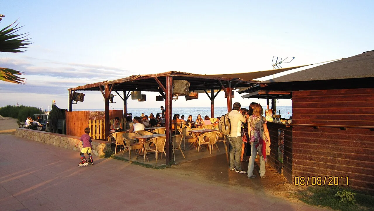 Chiringuito beach bar full of people in the sunlight